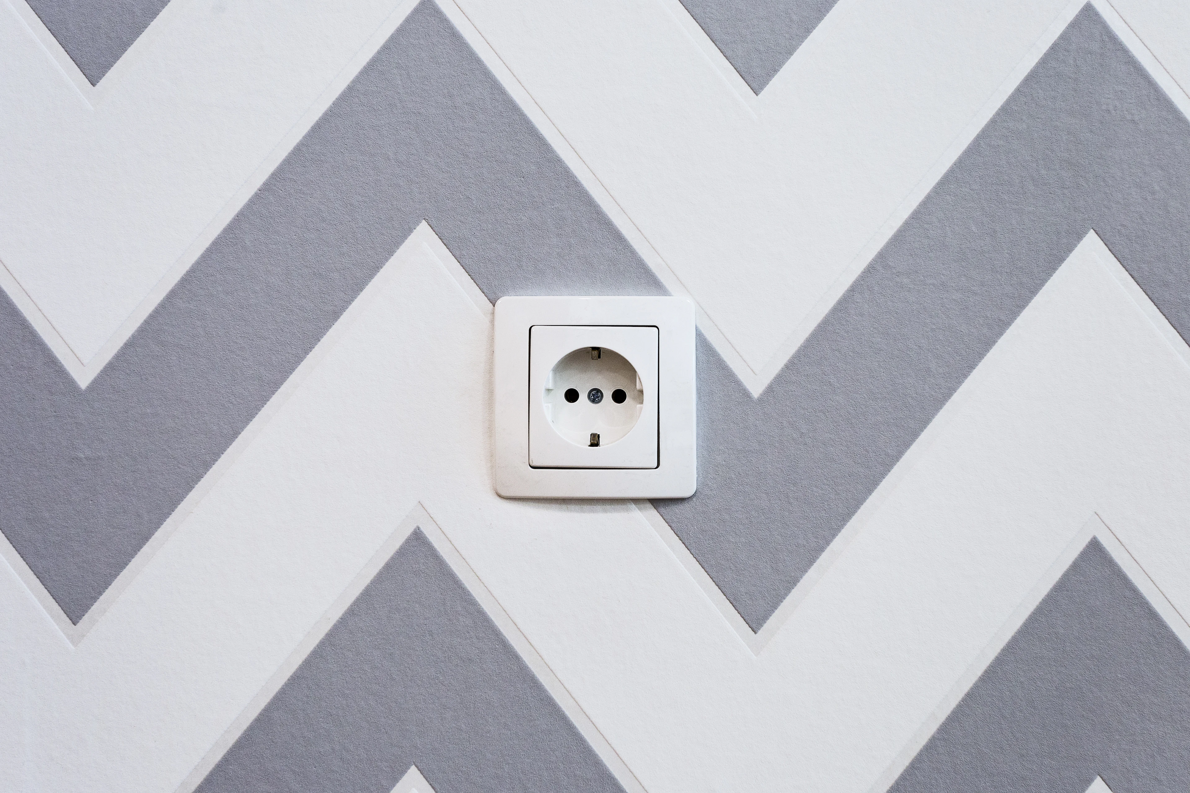 Power strip mounted on a wall with cables