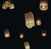 Elegant floating lanterns casting a warm glow in a tranquil setting.