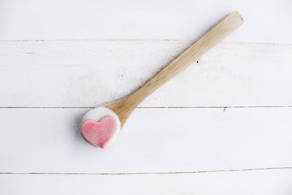 brown wooden stick and red and white pastry