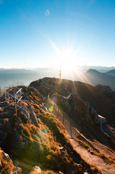 A sunrise over a rugged mountain trail symbolizing new beginnings and faith journeys.