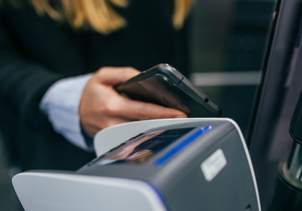 shallow focus photography of person holding smartphone