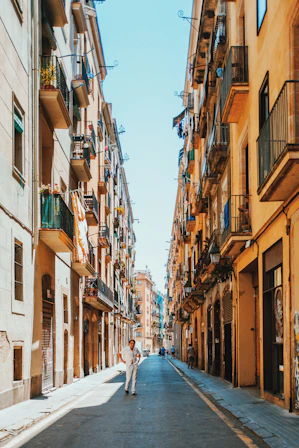 person walking between buildings