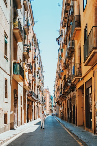 person walking between buildings