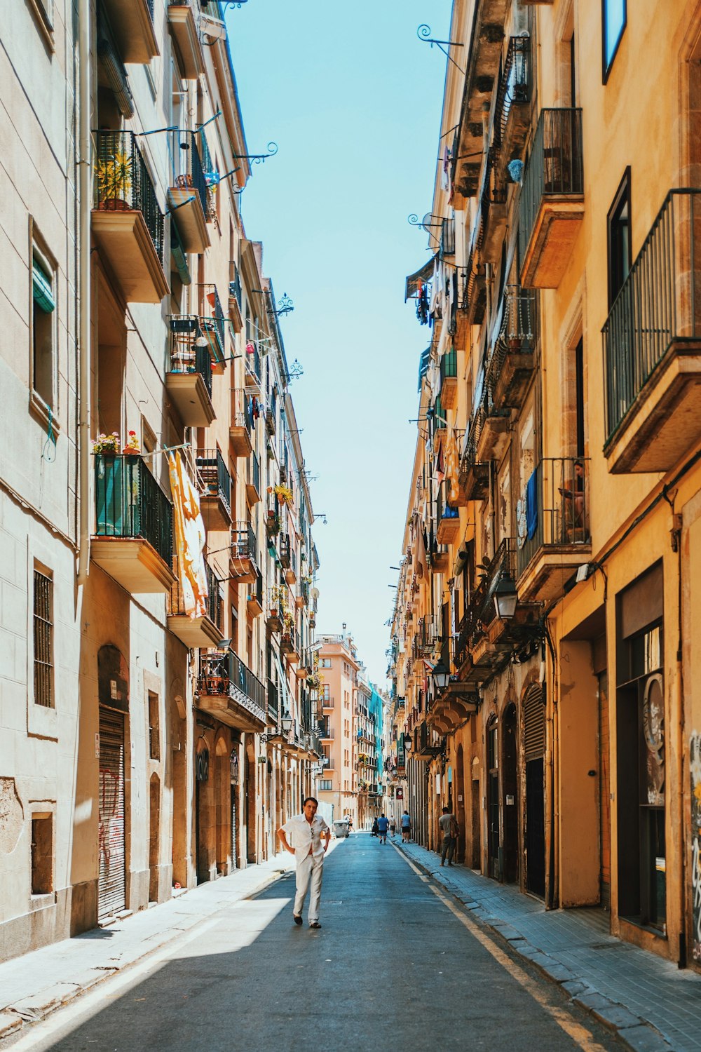 person walking between buildings