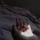 Close-up of hands resting gently on a soft cream fabric, bathed in warm light.