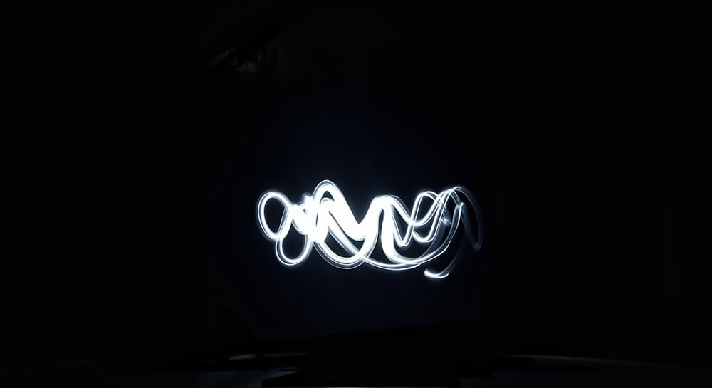 a black background with a light painting of a spiral