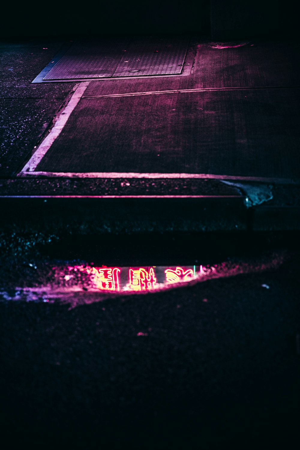 a reflection of a tennis court in a puddle of water