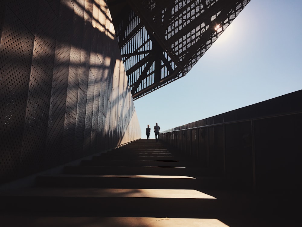 two people standing on staircase