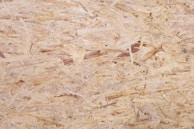 Close-up of waterproof OSB 3 material showing texture and quality finish on a locker door.