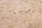 A close-up view of oriented strand board, showing an intricate pattern of compressed wood strands with a rough texture and varying shades of beige and brown.