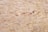 A close-up view of oriented strand board, showing an intricate pattern of compressed wood strands with a rough texture and varying shades of beige and brown.