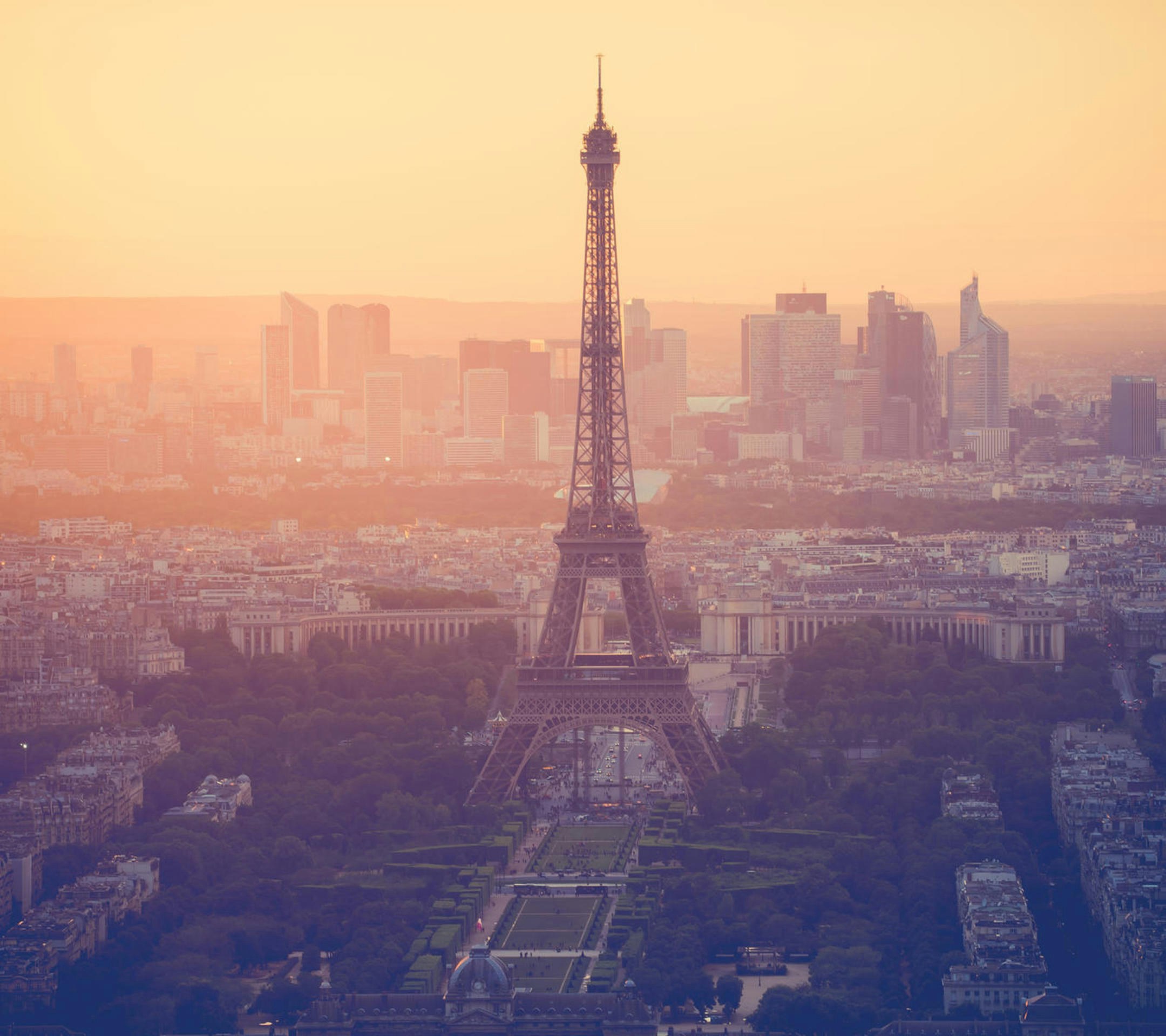 Eiffel Tower in Paris with sunset sky and city lights