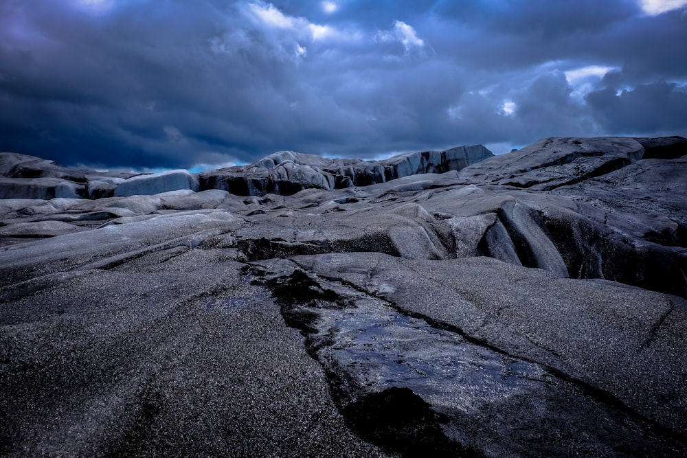 brown rock formation under black sky during daytime