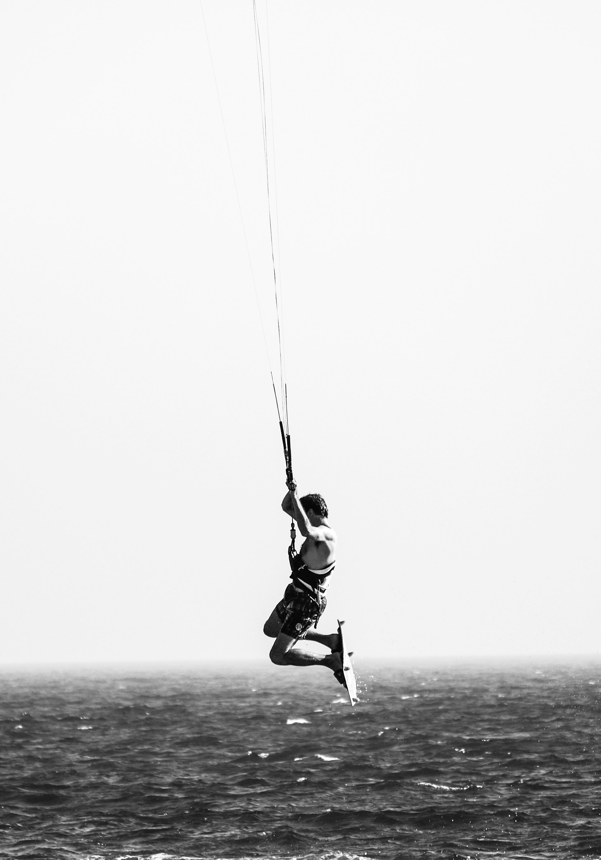 grayscale photo of man on body of water