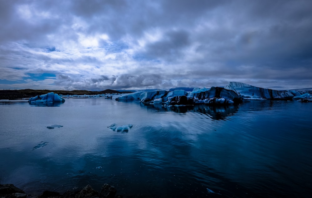 body of water under gray and white sky during daytime