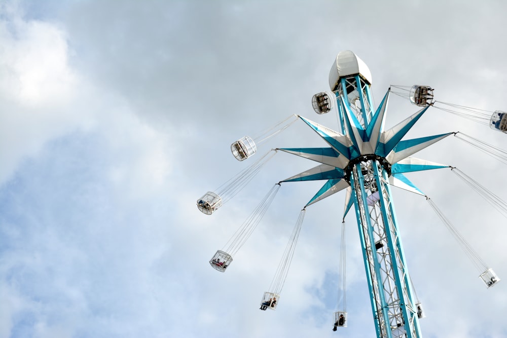 low-angle photography of gray and blue rotating coaster