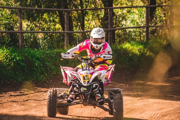 A friendly guide assisting tourists with ATV helmets in a lush green jungle setting.