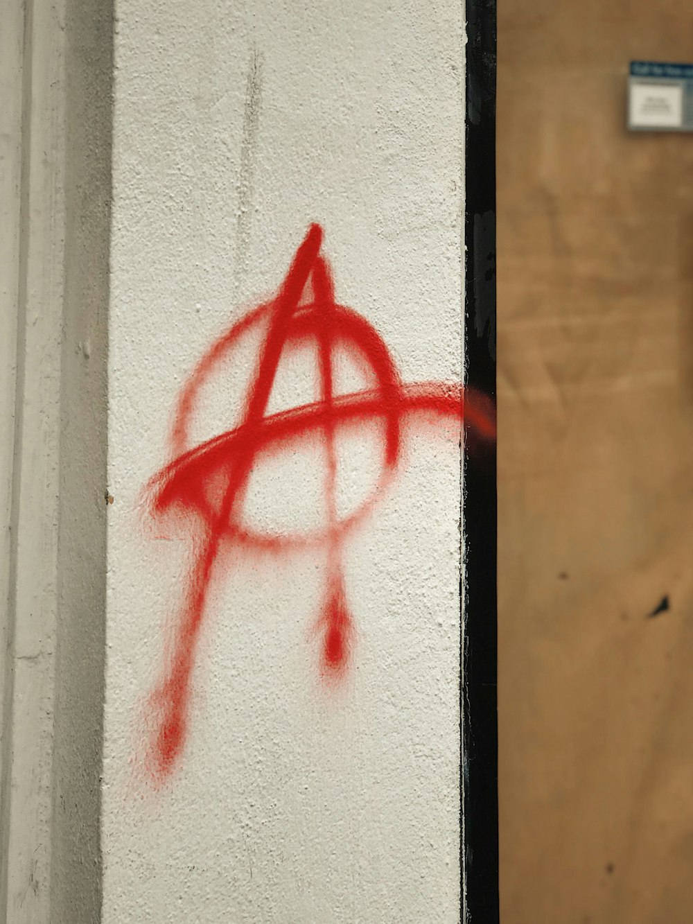 a wall with a red spray painted on it