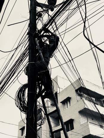 Technician installing fiber optic cables in an urban area