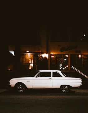 white car parked beside the street
