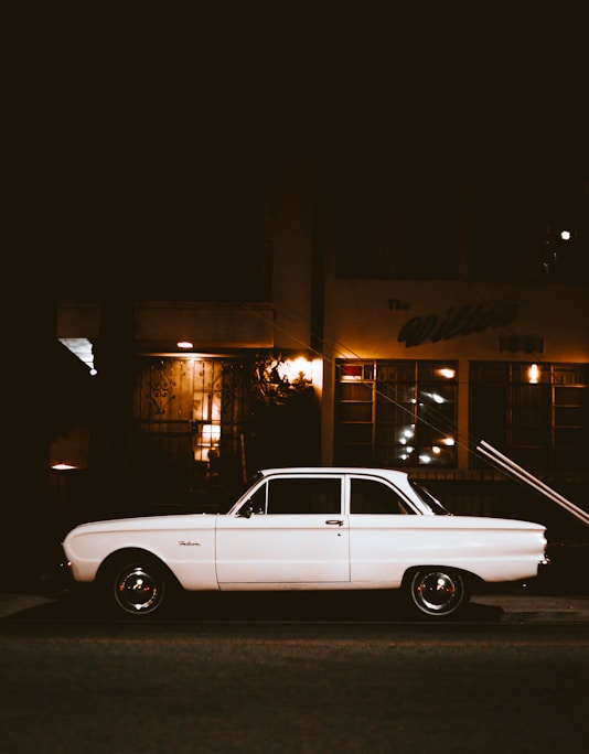 white car parked beside the street