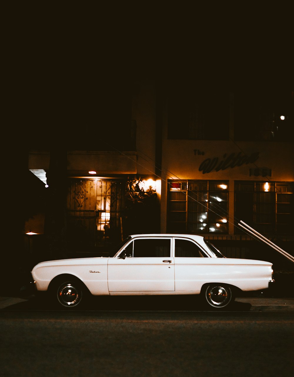 white car parked beside the street