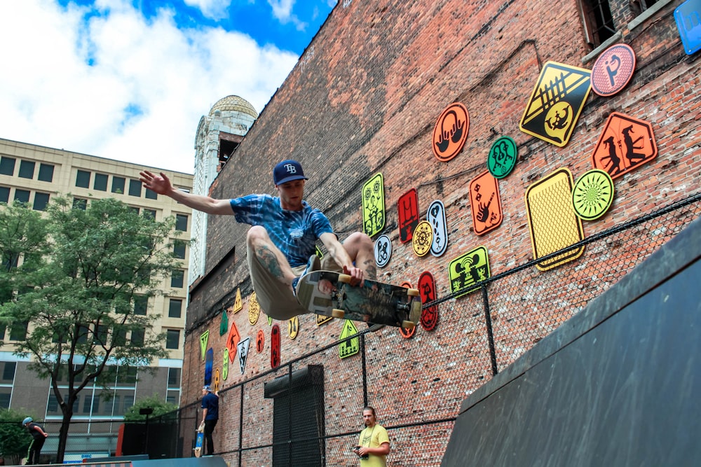 man skateboarding near brown concrete building during daytime