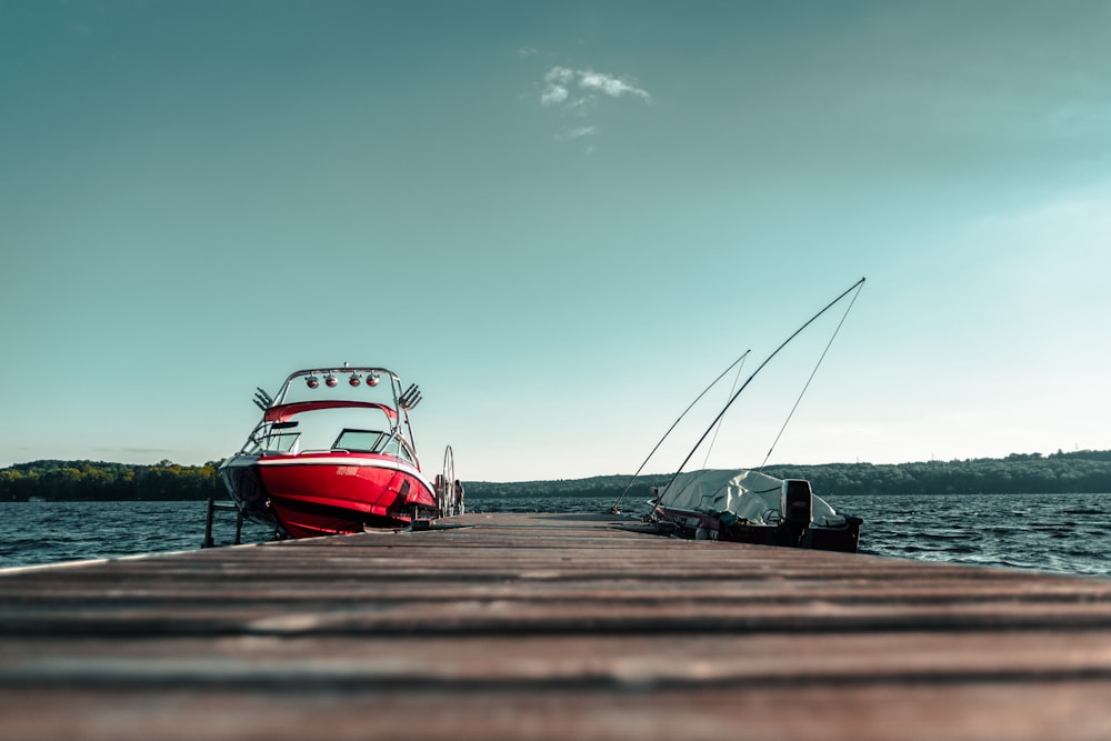 speedboat beside dock under clear sky