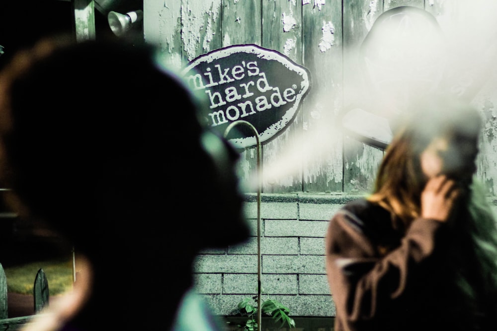 person blow smoke in closeup photography