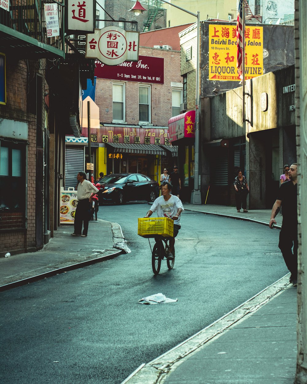 man riding bicycle in an alley