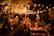 A romantic trio performing live at a cozy outdoor anniversary celebration under warm lights.