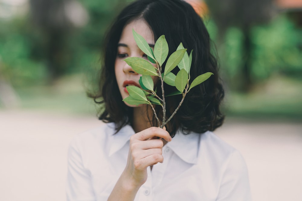 woman holding leaves