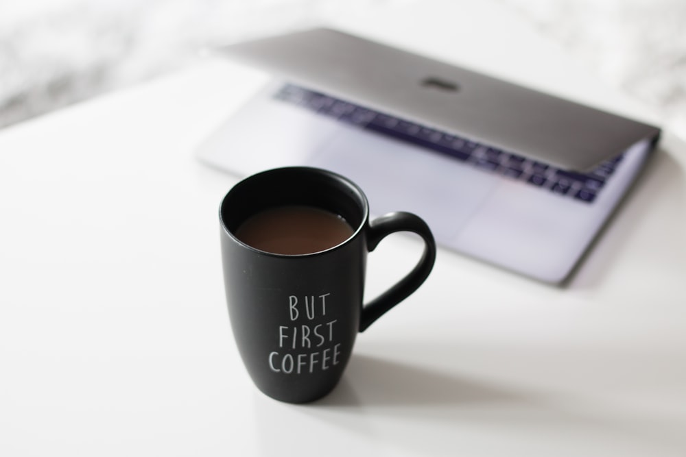 selective focus photo of filled black ceramic mug