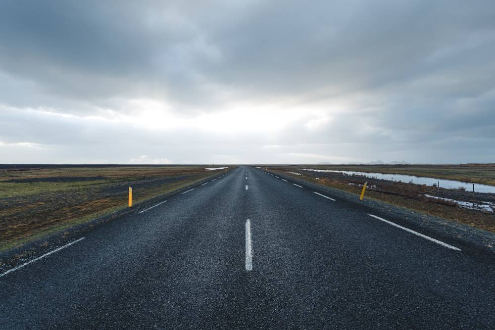 gray road under blue sky during daytime