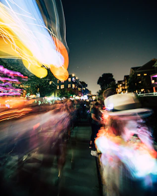 A dynamic event shot showing lively movement and vibrant lighting at a stylish urban gathering.