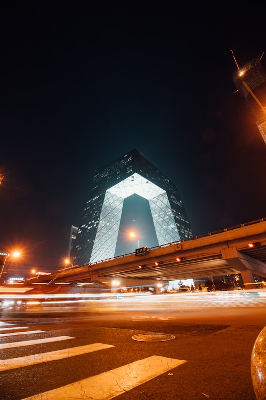 low angle photo of concrete lighted building in CCTV Headquarters China