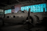 Veteran mentor sharing aviation stories with children inside a hangar.