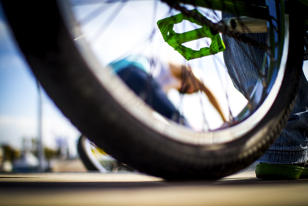 selective focus photo of bicycle wheel