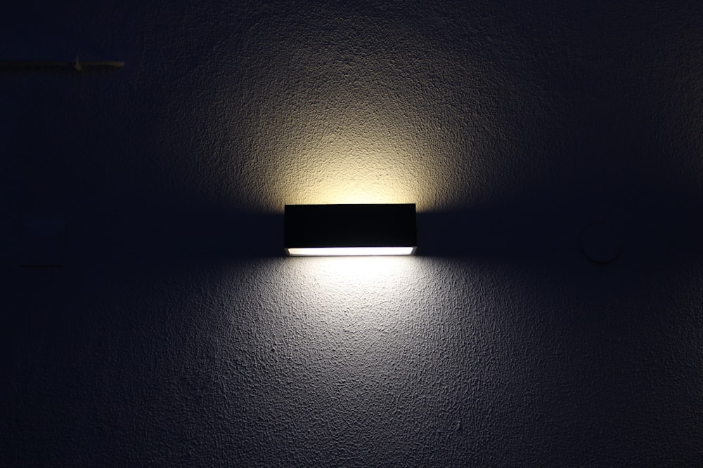 rectangular black sconces with dim light