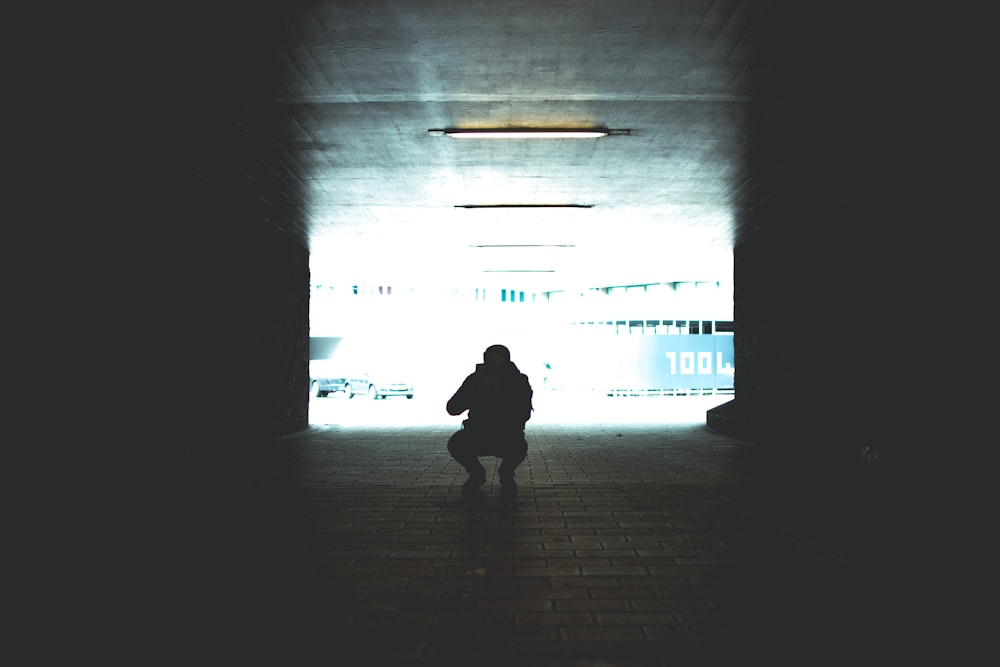 silhouette photography of man sitting