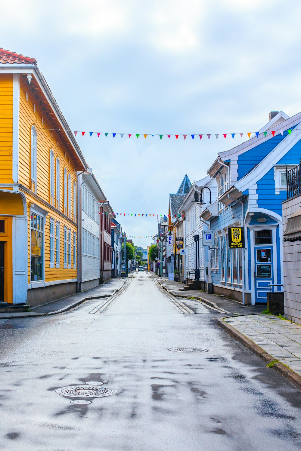 empty road between houses with buntings