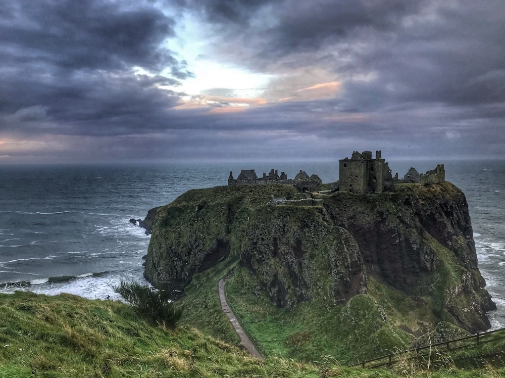 landscape photo of castle on top of mountain peak