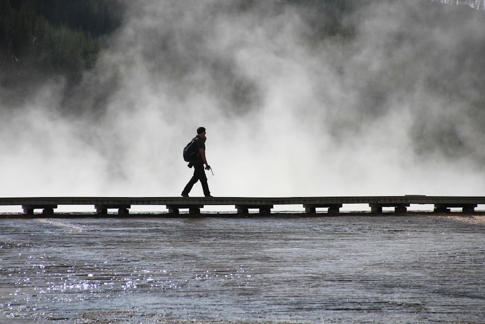 person walking on wooden dock