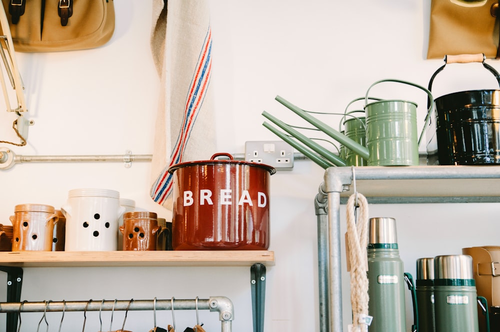 assorted-color ceramic canister on beige wooden rack inside room