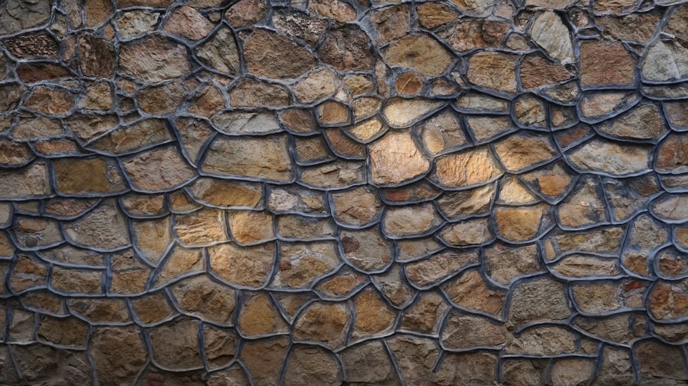 a close up of a stone wall with a metal grate