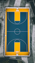 Aerial view of a uniquely designed basketball court shaped like a giant paint palette.