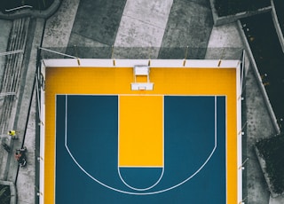 aerial view photography of yellow and blue basketball court