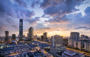 gray high-rise buildings under gray clouds during golden hour
