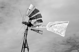 A weathered windmill standing tall against a dusky sky, symbolizing hope in a post-apocalyptic world.
