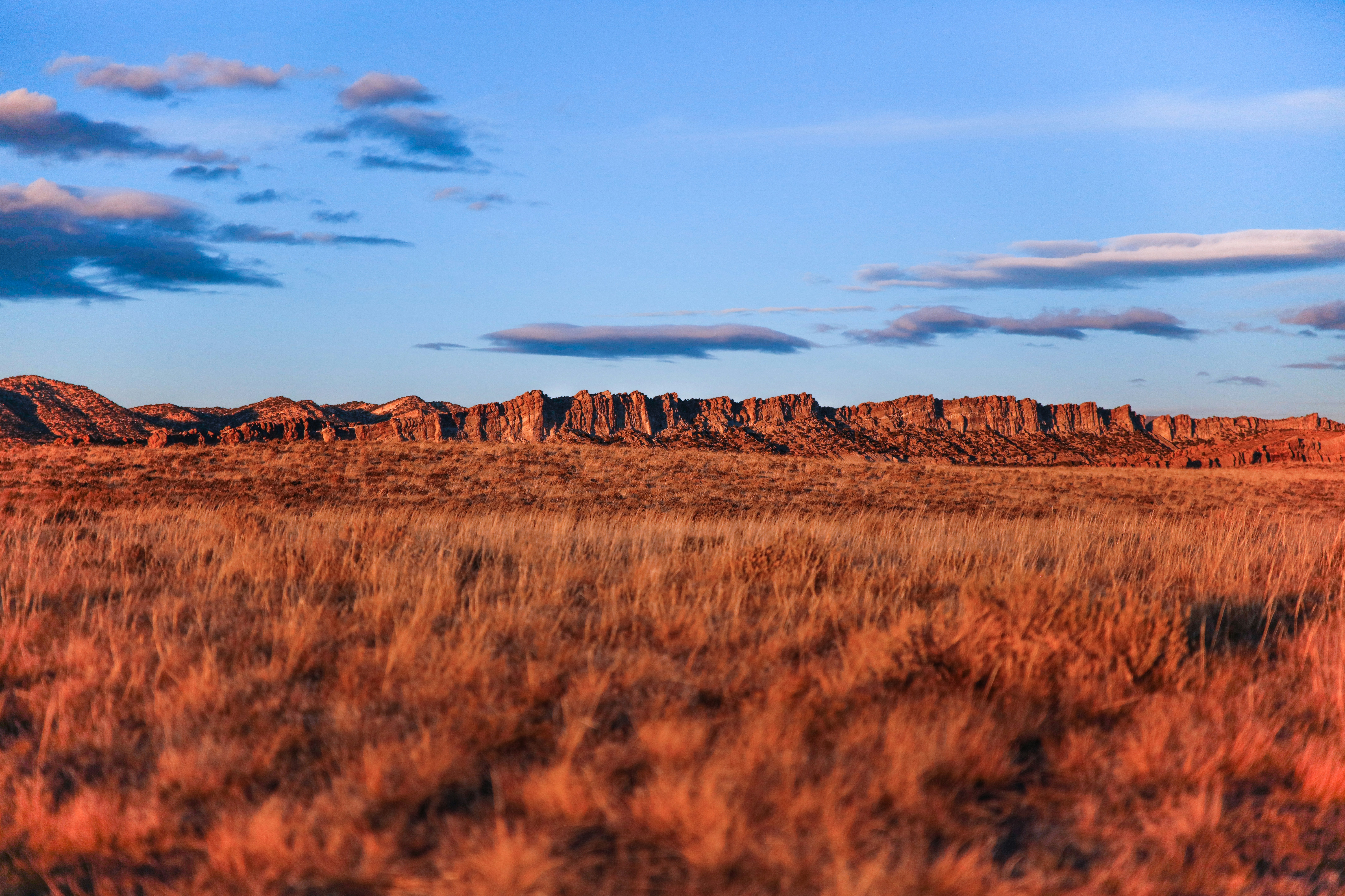 monument valley under white clouds during daytime saturated teams background
